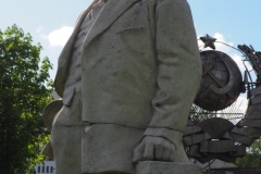 VI Lenin standing, resting hand on pillar