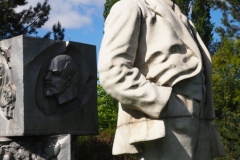 VI Lenin standing, resting hand on pillar